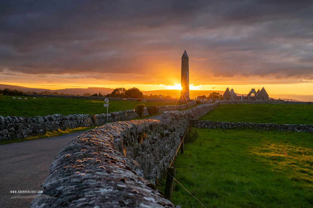 Kilmacduagh Monastery Burren Clare Ireland - church,july,kilmacduagh,lowlands,summer,sunset,sunstar,tower,walls