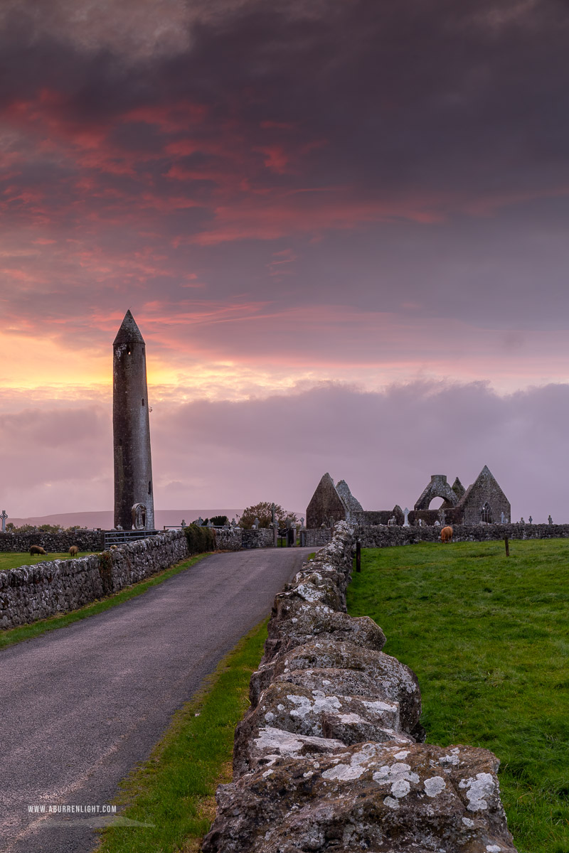 Kilmacduagh Monastery Burren Clare Ireland - church,gort,kilmacduagh,landmark,pink,september,summer,sunset,tower,lowland